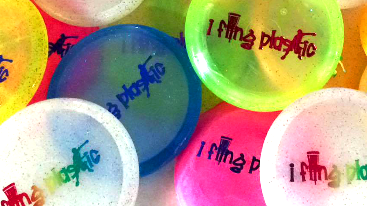 A group of frisbees with different colors and designs.