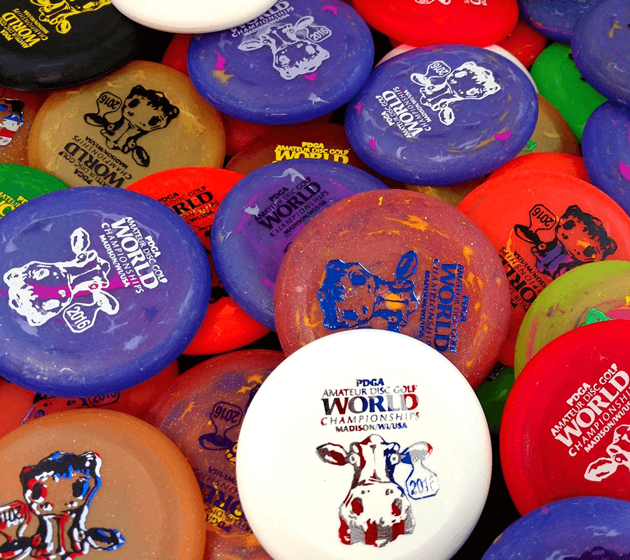 A pile of frisbees with different designs on them.